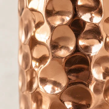 A close-up of warm hand-hammered copper